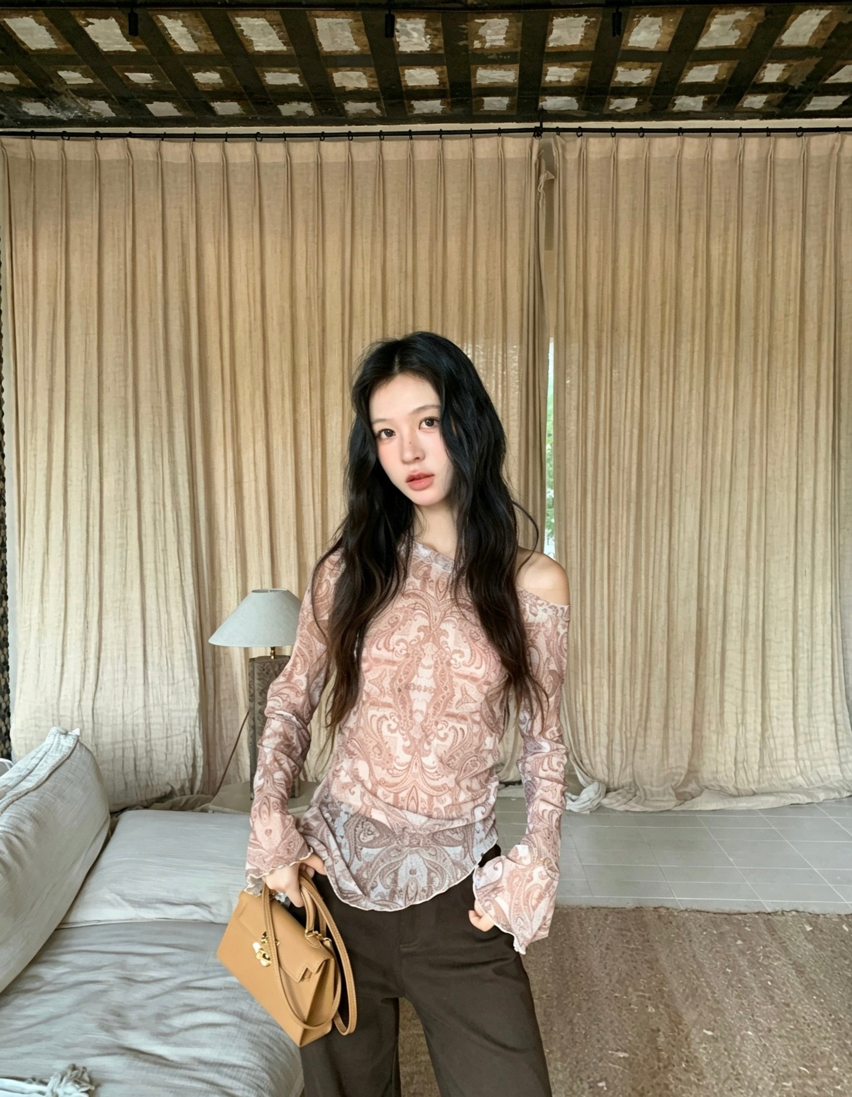 Model wearing brown retro print asymmetrical off-shoulder shirt