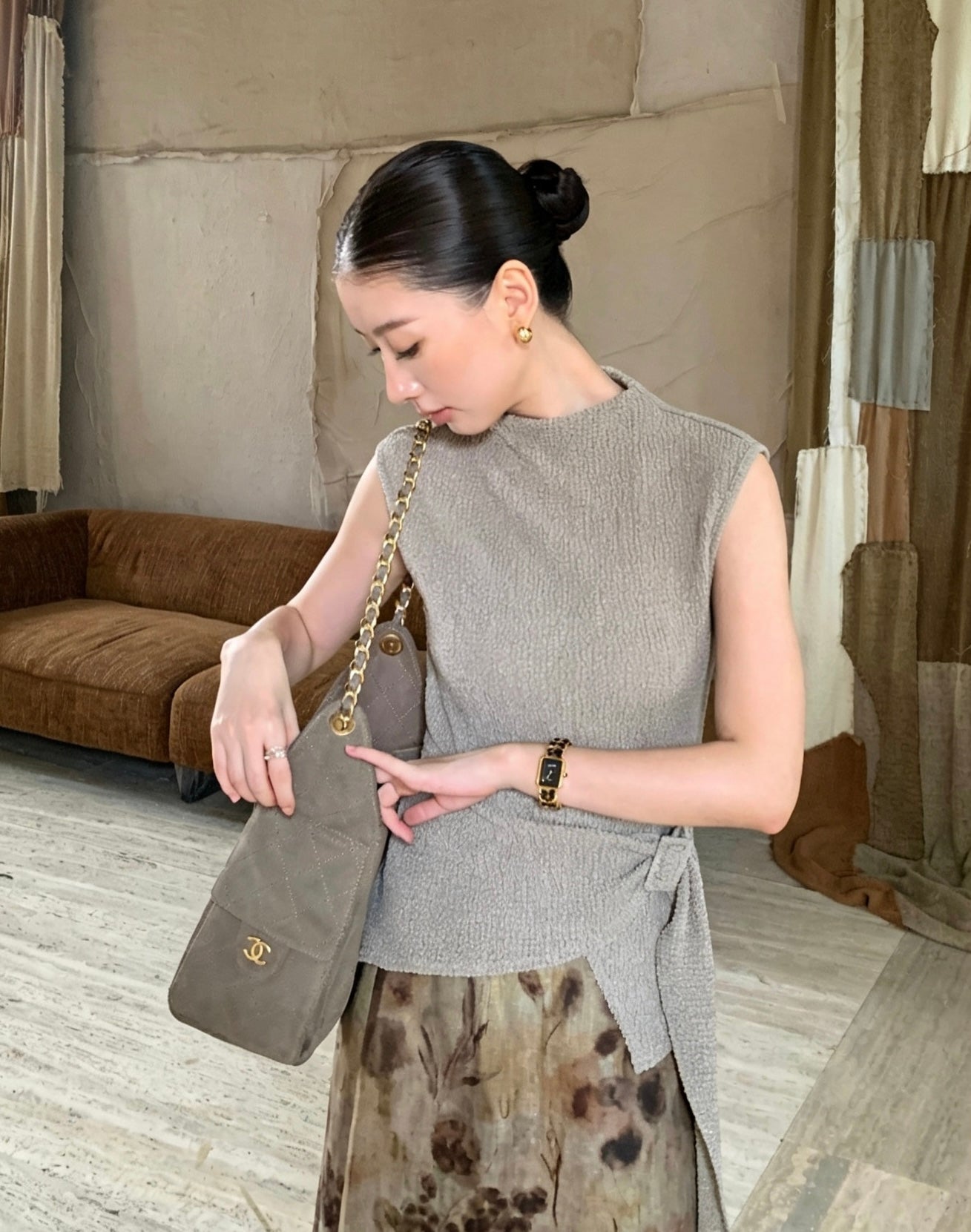 Model wearing apricot mock neck textured sleeveless top
