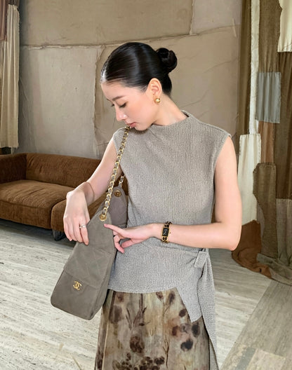 Model wearing apricot mock neck textured sleeveless top