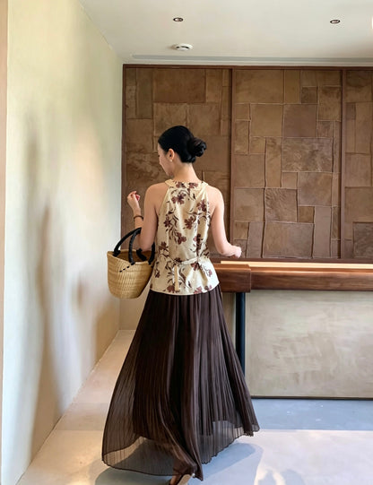 Back view of a model wearing a dark brown pleated maxi skirt
