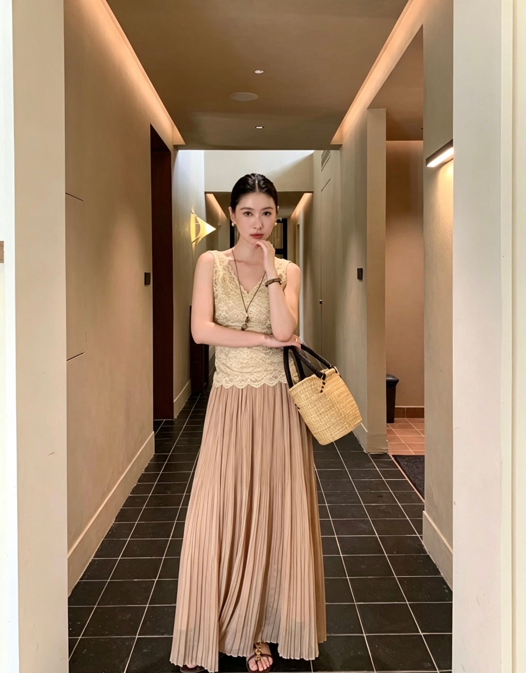 Model twirling in an apricot pleated maxi skirt