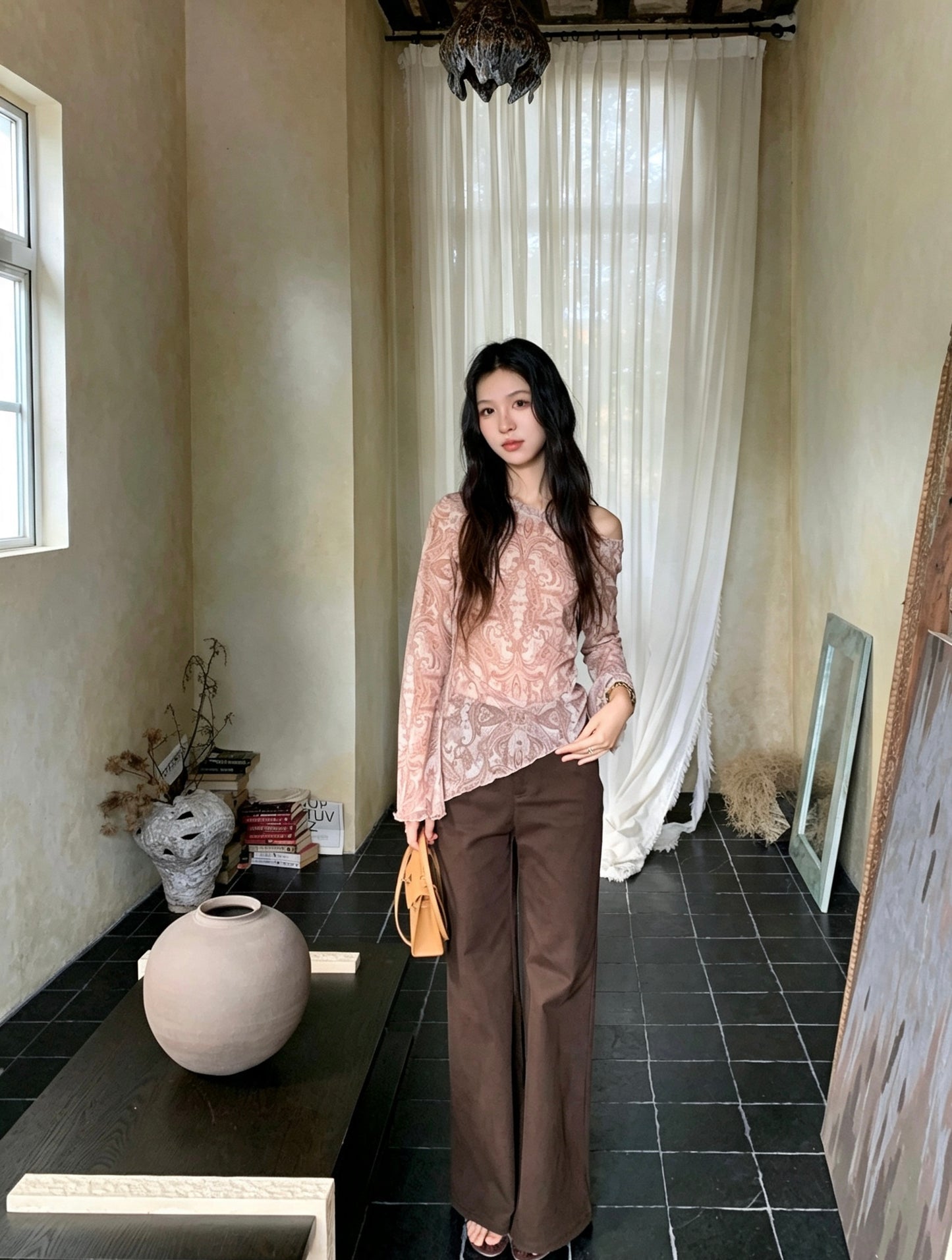 Model in sheer paisley top and brown pants