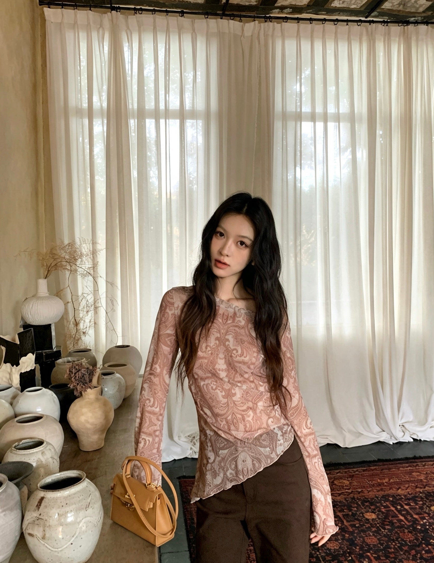 Model leaning on console table in retro print top