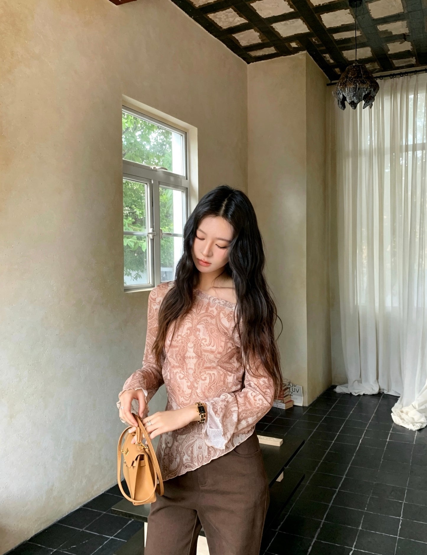 Model looking down wearing retro print off-shoulder top