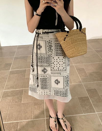 Woman taking a mirror selfie wearing an apricot retro ink print midi skirt