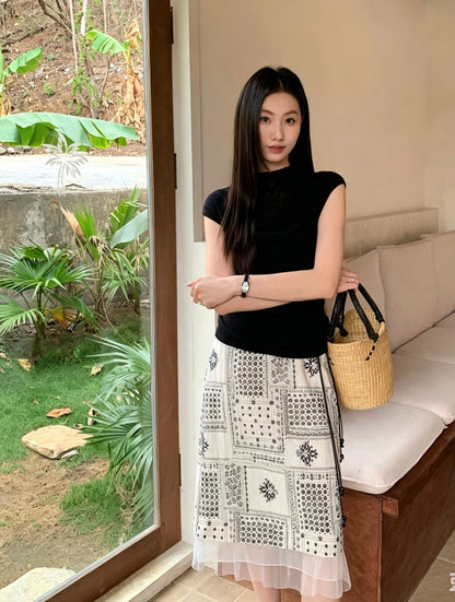 Model standing indoors wearing a French style patterned midi skirt