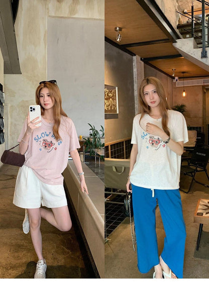 Split image of a woman wearing purple and white dog graffiti t-shirts