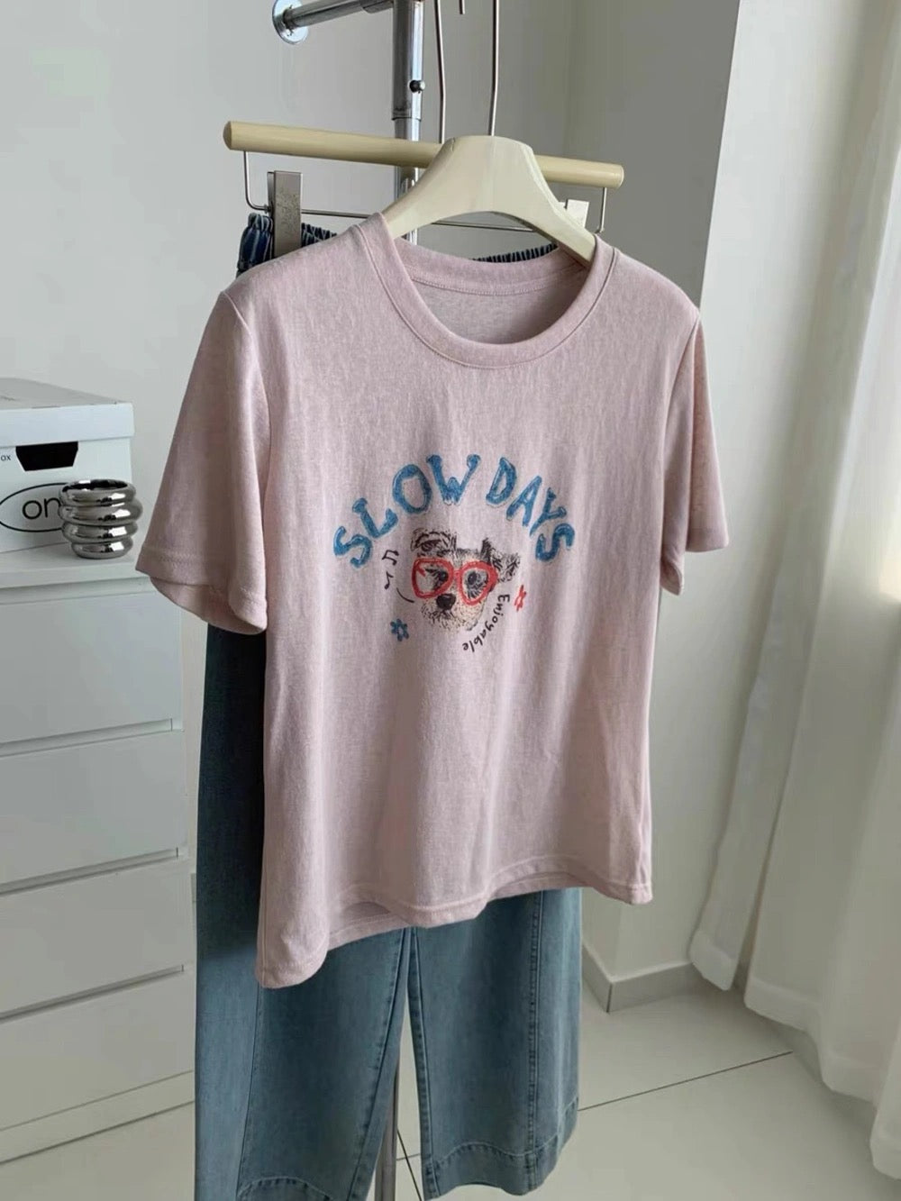 Purple dog graffiti t-shirt hanging on a rack