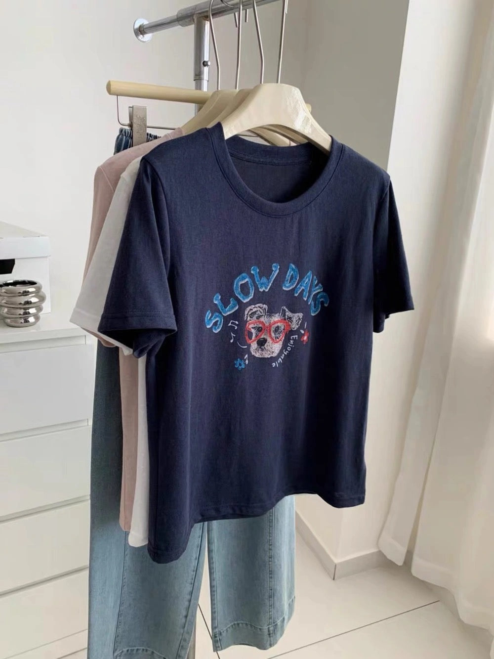 Navy dog graffiti t-shirt hanging on a rack