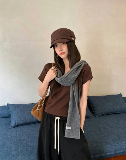 Model wearing a brown U-neck short-sleeve t-shirt