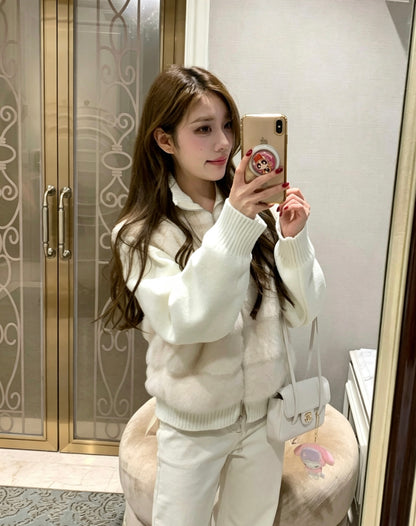 Woman taking mirror selfie in apricot faux fur knit jacket