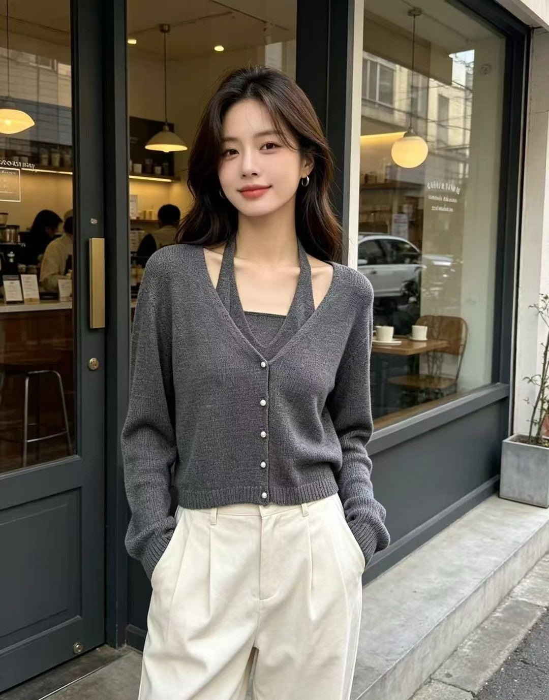 Model wearing a dark grey French halter pearl button faux two-piece knit top