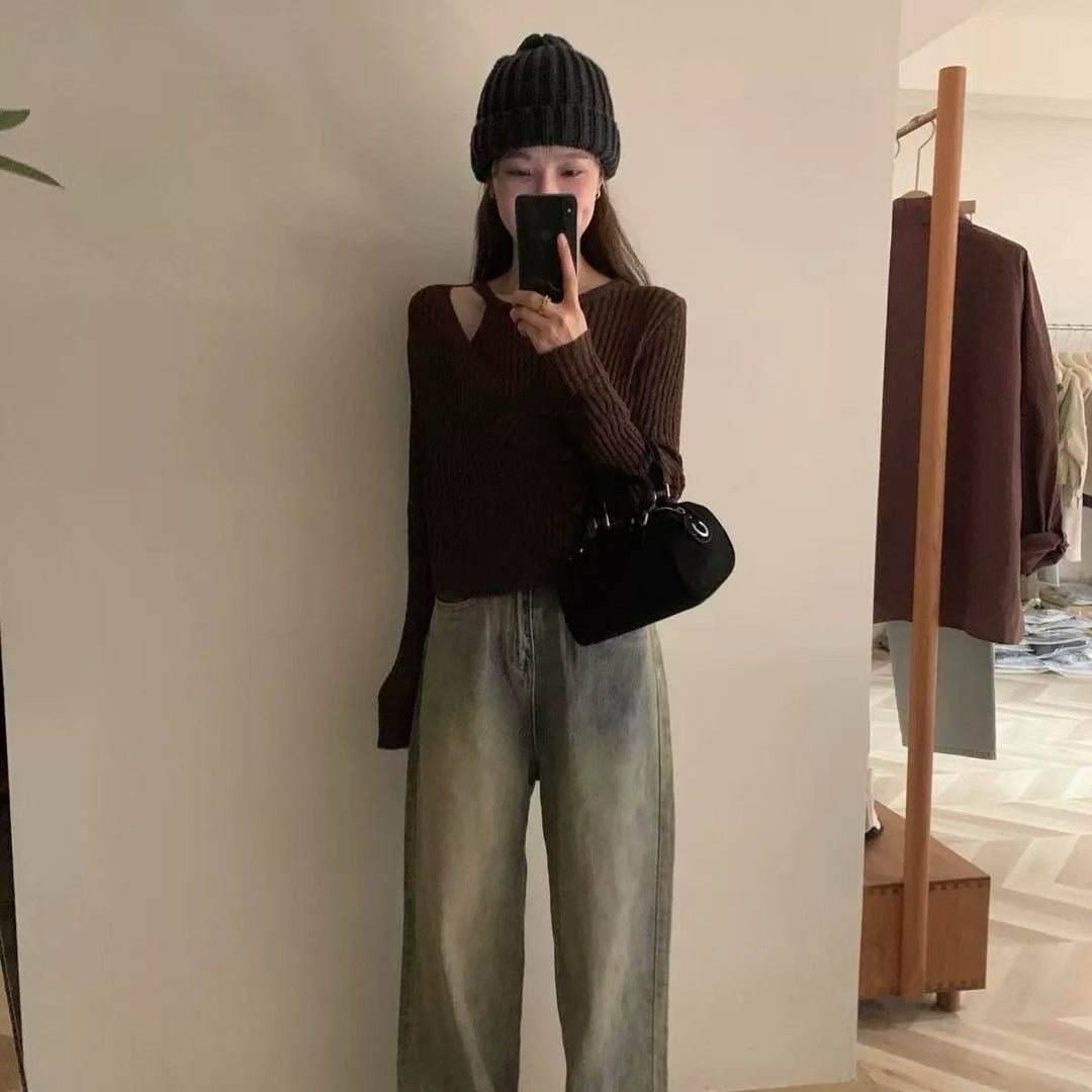 Model taking a mirror selfie in a brown ribbed knit top