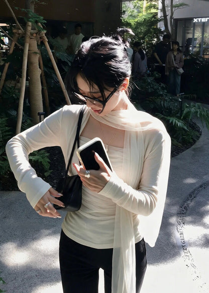 Cream-colored mesh scarf top detail