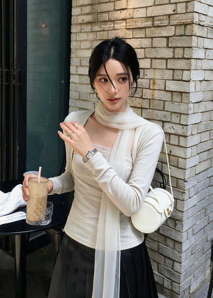 Woman wearing white mesh scarf top