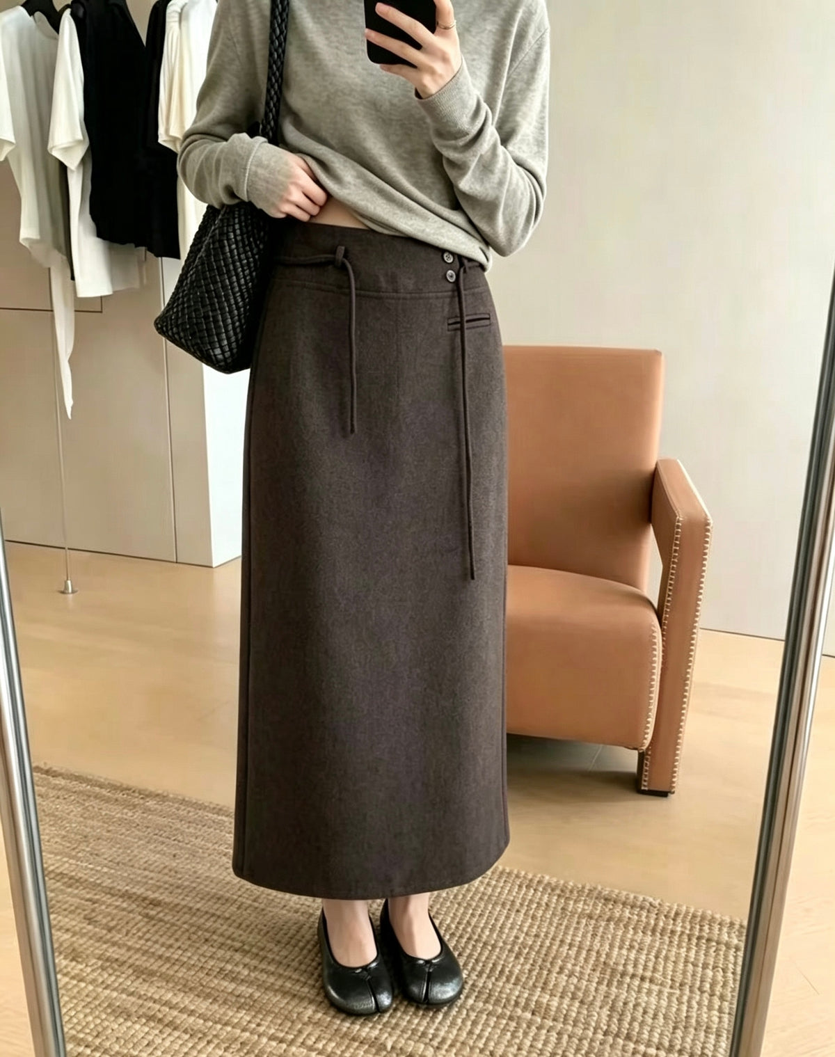 Mirror selfie of a model wearing a dark grey Korean retro draped high-waisted A-line skirt