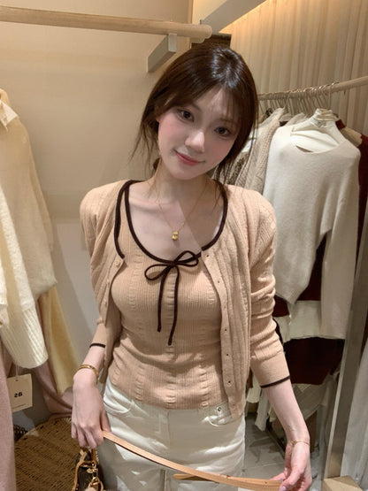 Woman wearing orange-pink ribbed knit camisole and cardigan set