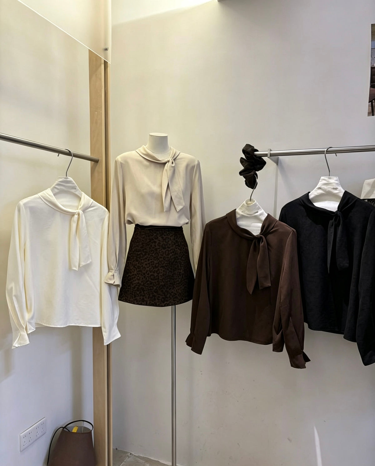 Tie-neck long-sleeve shirts in various colors on display