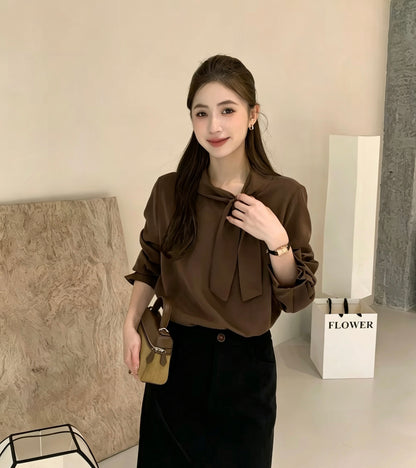Model wearing dark brown tie-neck long-sleeve shirt